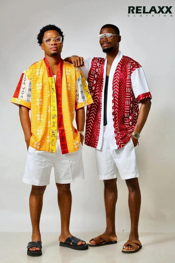 Deux hommes en chemises imprimées manches courtes, jaune et rouge, shorts blancs